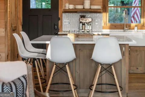 a view of a patio with a dining table and chairs with wooden floor