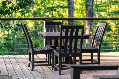 a view of balcony with wooden floor and outdoor seating