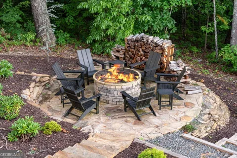 a view of a dinning table and chairs in backyard of the house