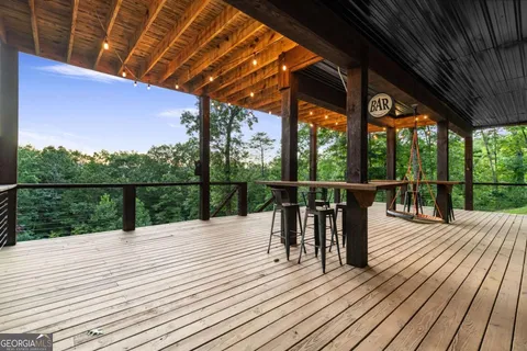 a view of house with a big yard and large trees