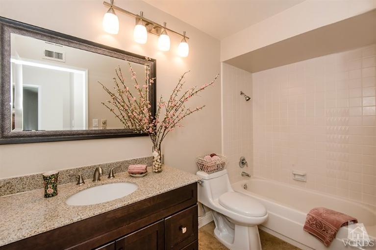 3025 Springfield Street Simi Valley, CA 93063 - Photo 20 of 24 a bathroom with a granite countertop sink and a mirror