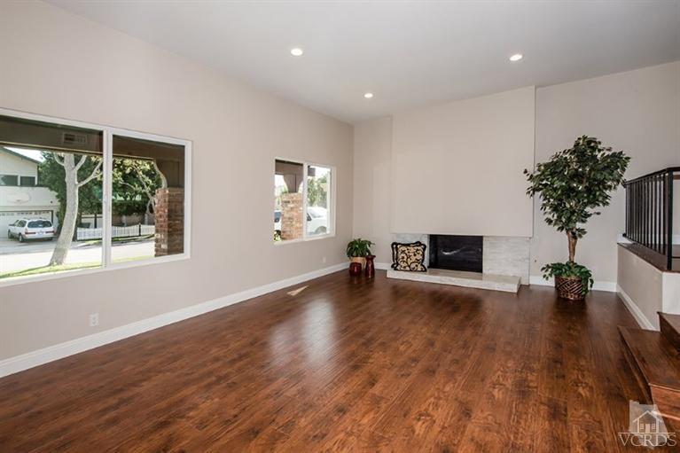 3025 Springfield Street Simi Valley, CA 93063 - Photo 3 of 24 a view of a livingroom with wooden floor and a fireplace