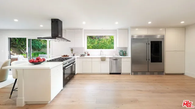 a kitchen with a sink cabinets and window