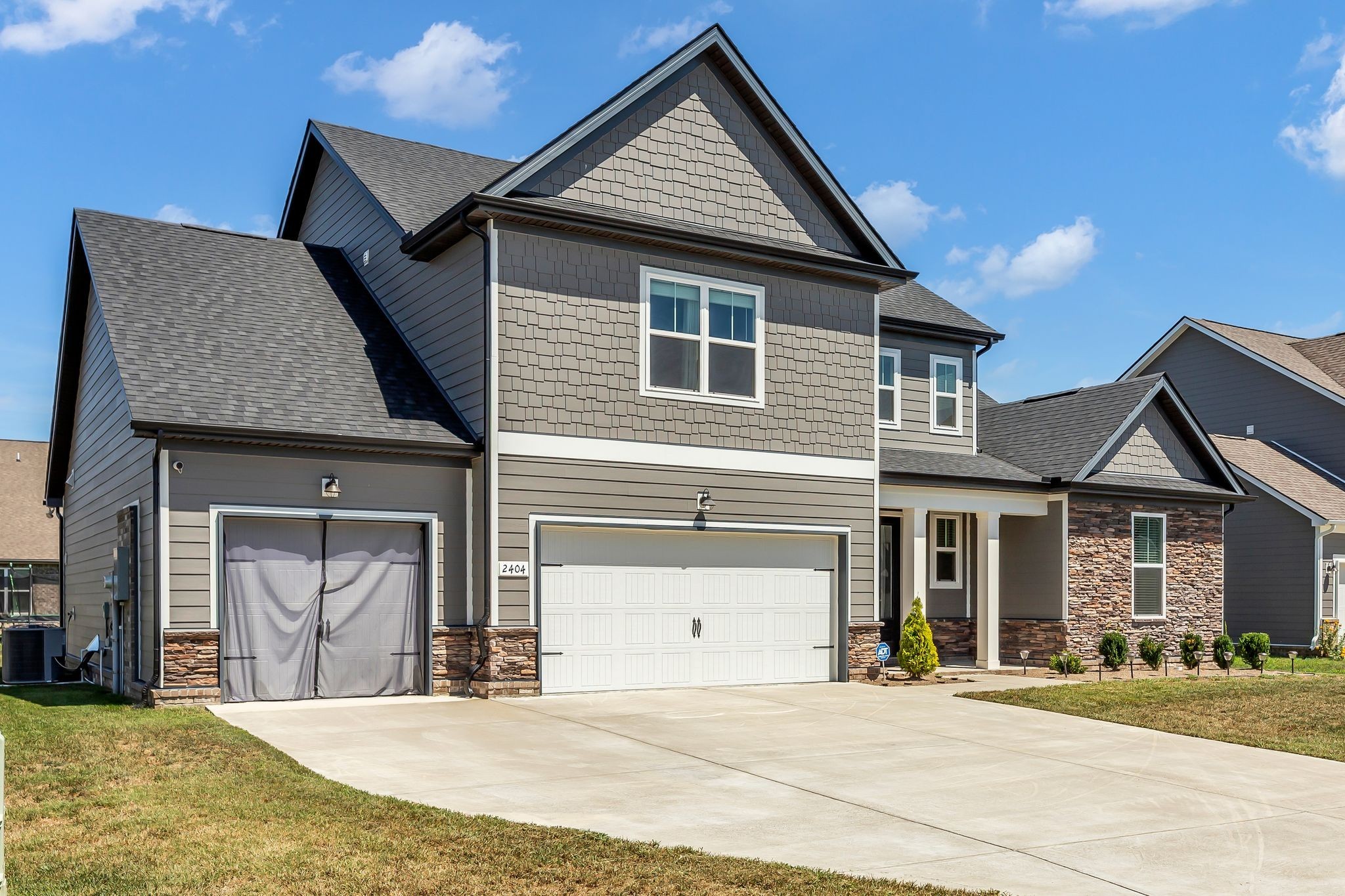 2404 Beaver Drive Murfreesboro, TN 37128 - Photo 4 of 42 a front view of a house with a garden and yard