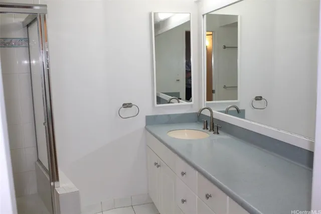 a bathroom with a double vanity sink and a mirror