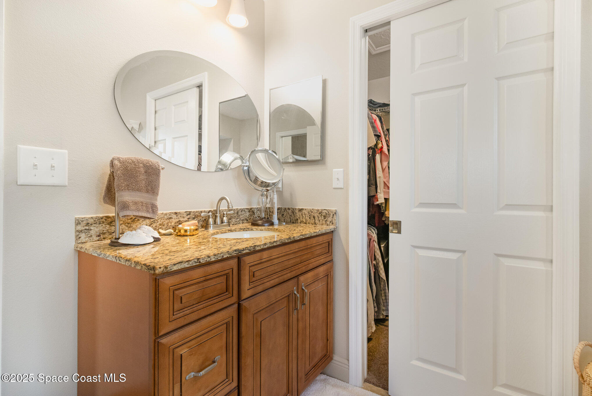 1484 Independence Avenue Melbourne, FL 32940 - Photo 14 of 30 a bathroom with a sink and a mirror