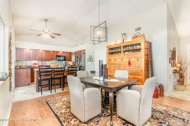 a dining room with furniture a rug and wooden floor