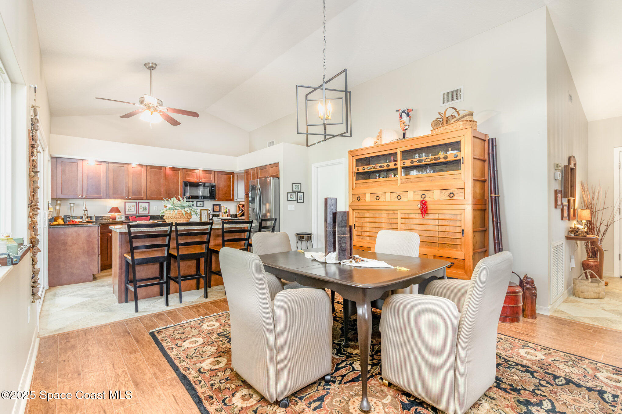 1484 Independence Avenue Melbourne, FL 32940 - Photo 4 of 30 a dining room with furniture a rug and wooden floor