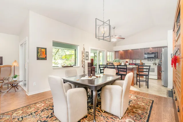 a dining room with furniture a window and wooden floor
