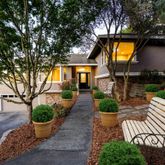a house view with a seating space and garden