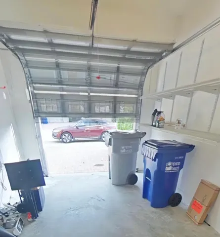 a room with water heater and wooden cabinets