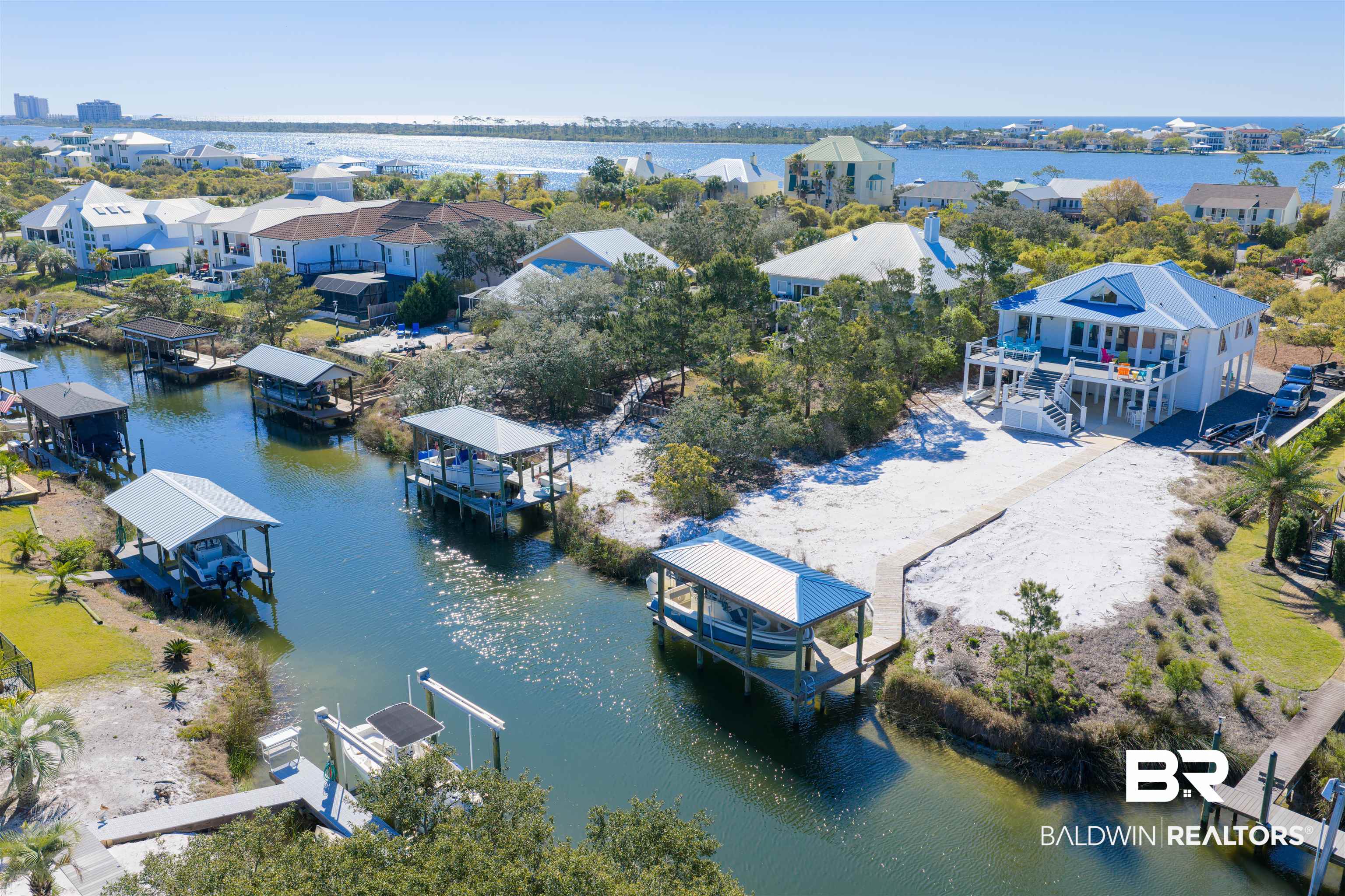 32315 River Road Orange Beach, AL 36561 - Photo 4 of 68 Aerial perspective of suburban area with a nearby body of water