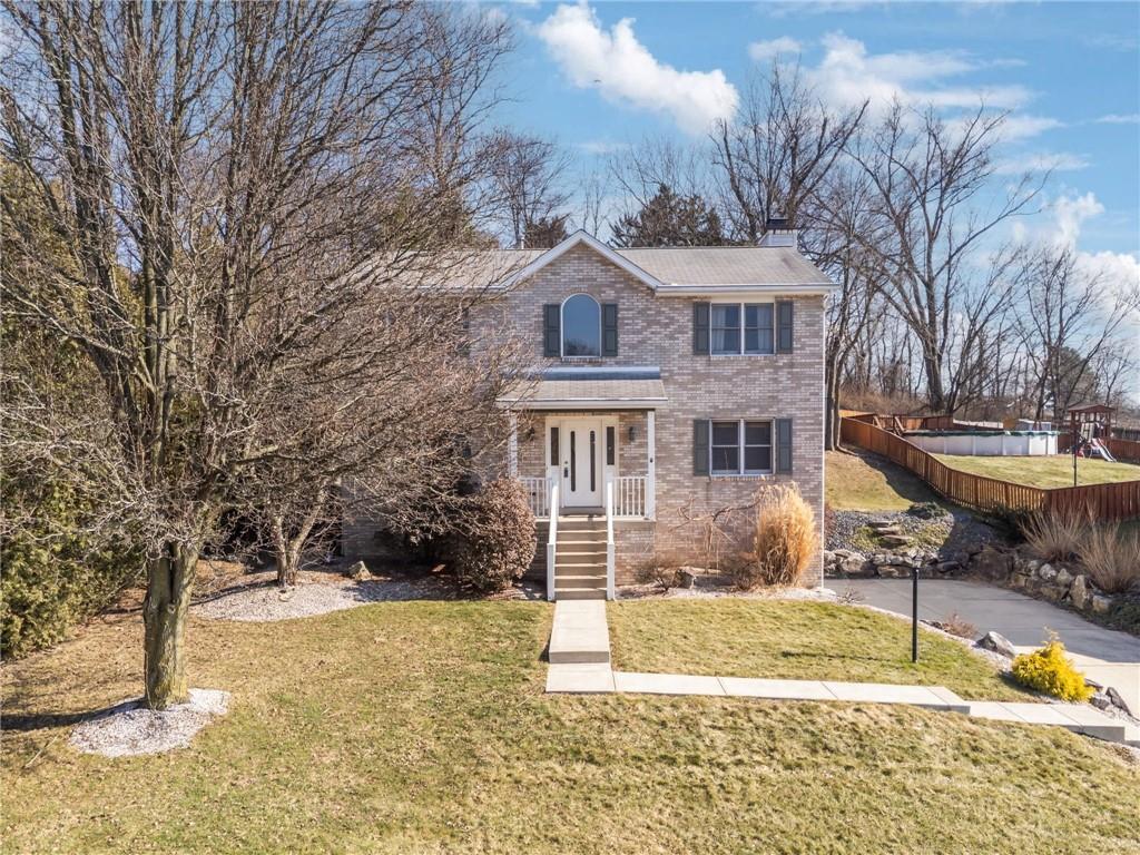 a front view of a house with a yard
