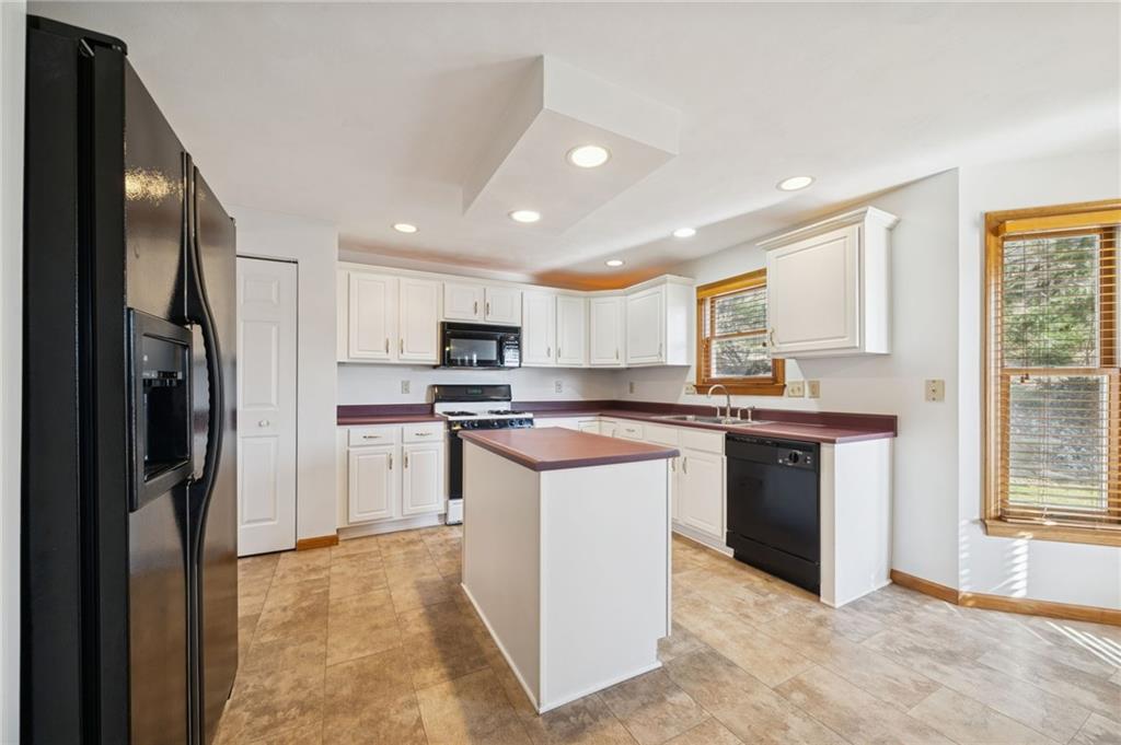 1051 Finchley Road Irwin, PA 15642 - Photo 12 of 36 a kitchen with stainless steel appliances granite countertop a refrigerator stove top oven and sink