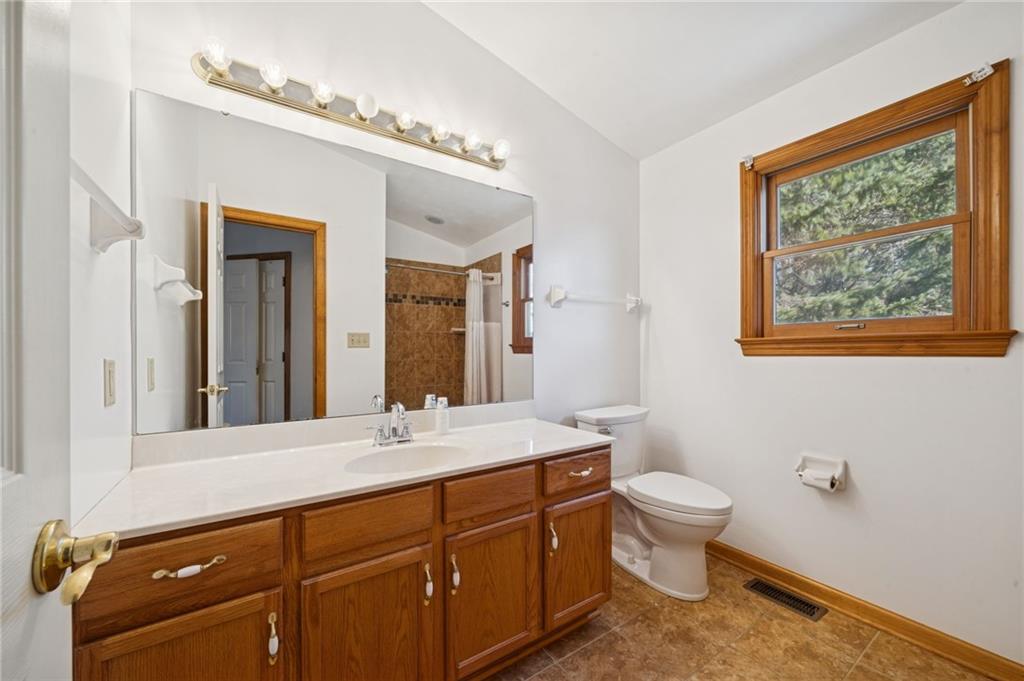 1051 Finchley Road Irwin, PA 15642 - Photo 23 of 36 a bathroom with a sink mirror vanity and toilet