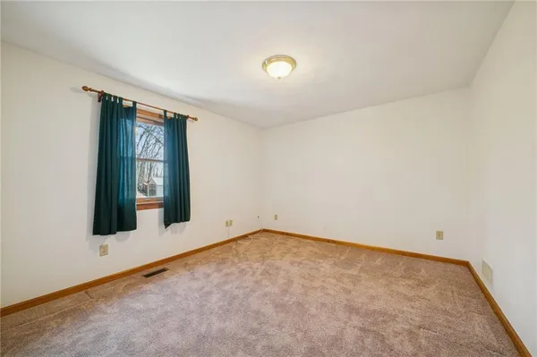 an empty room with closet and windows