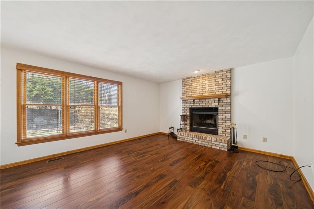 1051 Finchley Road Irwin, PA 15642 - Photo 6 of 36 wooden floor fireplace and windows in an empty room