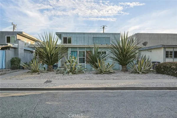 a view of a palm trees front of a house