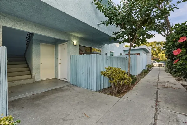 a view of a house with a potted plant and a large window