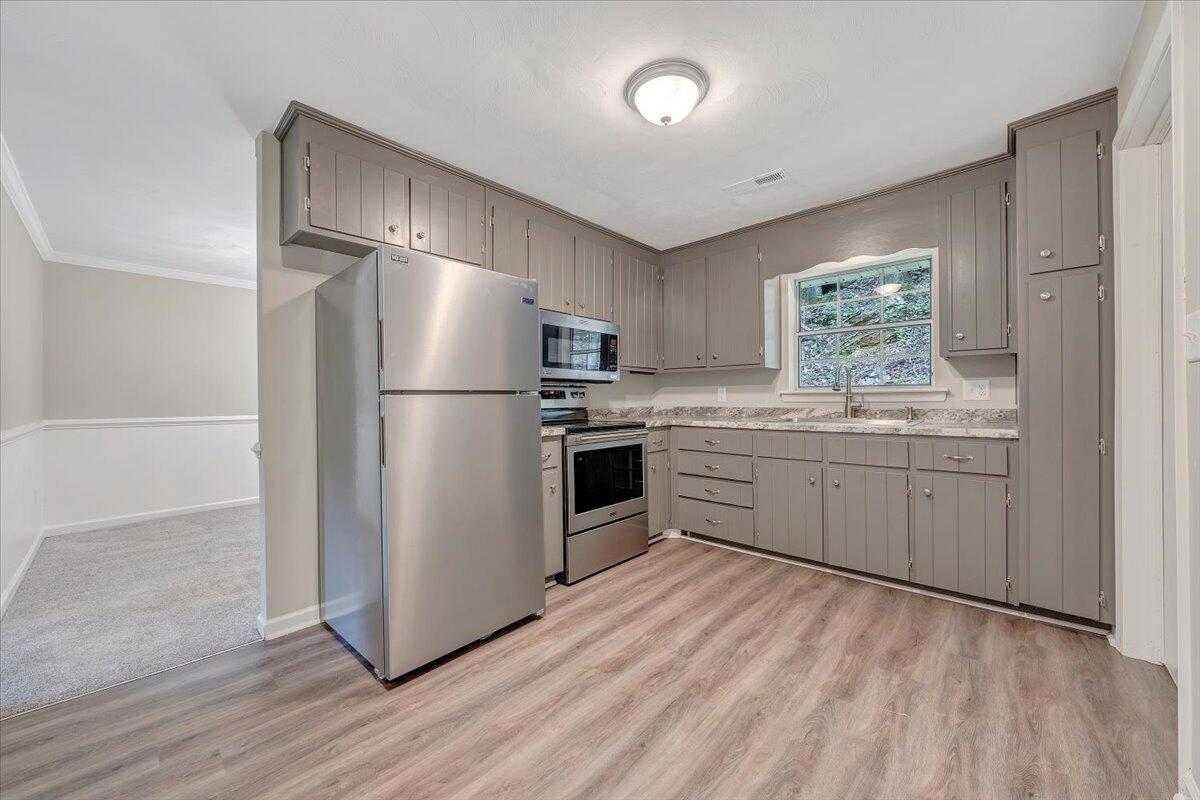 5679 Franklin Road Roanoke, VA 24014 - Photo 12 of 36 a kitchen with a refrigerator and a sink