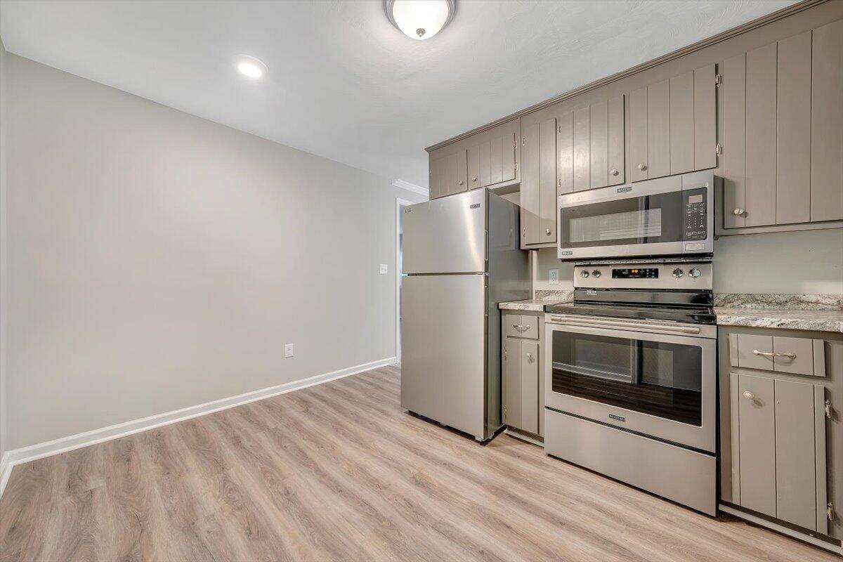 5679 Franklin Road Roanoke, VA 24014 - Photo 14 of 36 a kitchen with a stove a microwave and a refrigerator