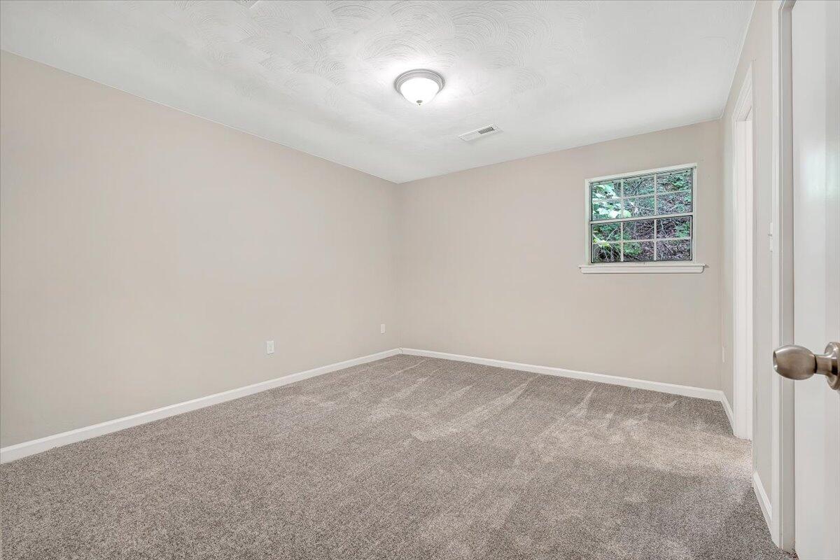 5679 Franklin Road Roanoke, VA 24014 - Photo 17 of 36 an empty room with a workbench