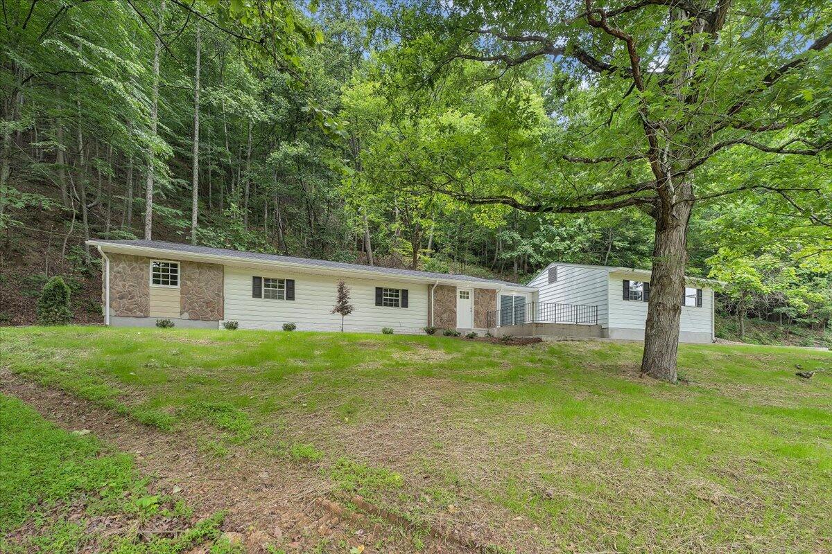 5679 Franklin Road Roanoke, VA 24014 - Photo 28 of 36 a front view of a house with a garden