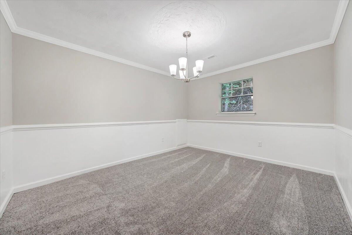 5679 Franklin Road Roanoke, VA 24014 - Photo 9 of 36 an empty room with a chandelier fan and windows