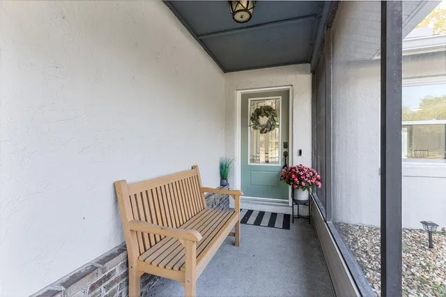 a view of a hallway with wooden floor and a livingroom