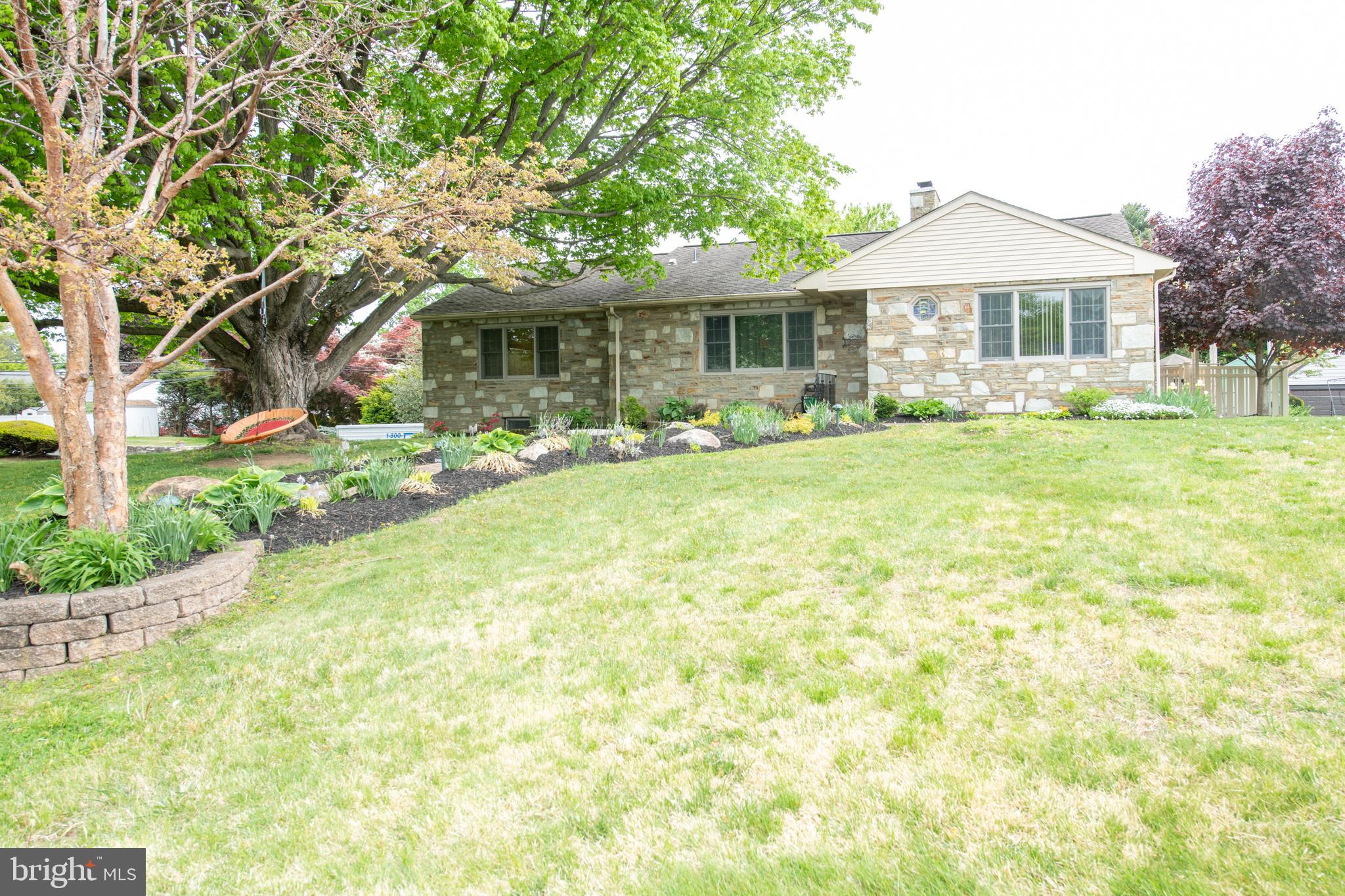 1259 Glenbrook Road Huntingdon Valley, PA 19006 - Photo 2 of 78 a front view of a house with a garden and porch
