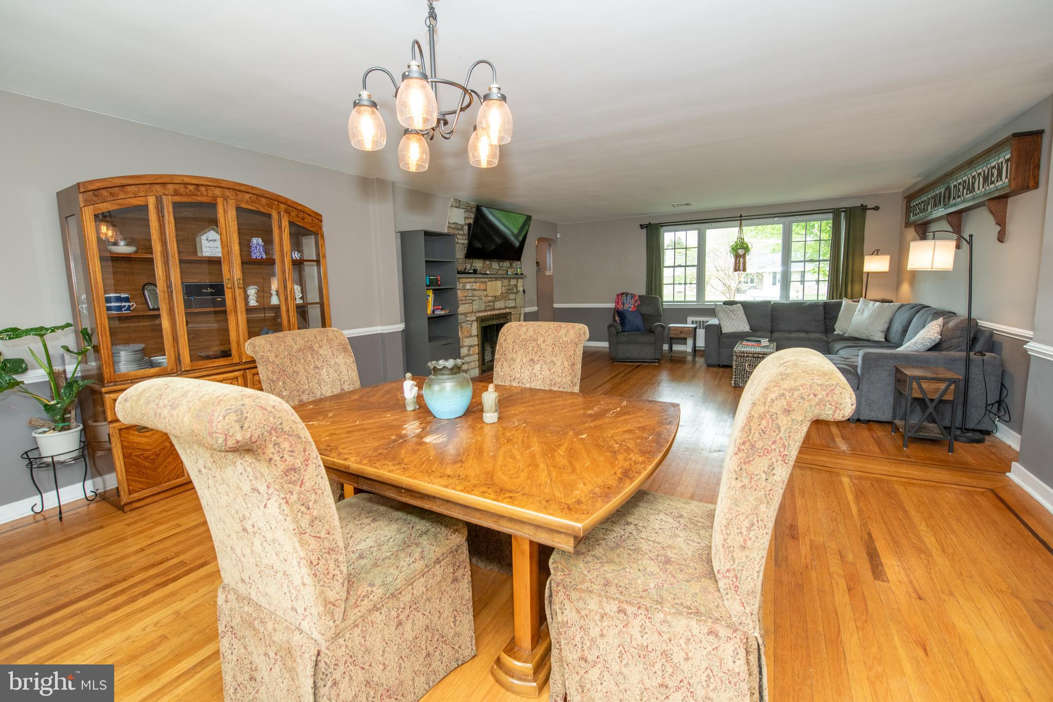 1259 Glenbrook Road Huntingdon Valley, PA 19006 - Photo 30 of 78 a dining room with wooden floor a chandelier a glass table and chairs