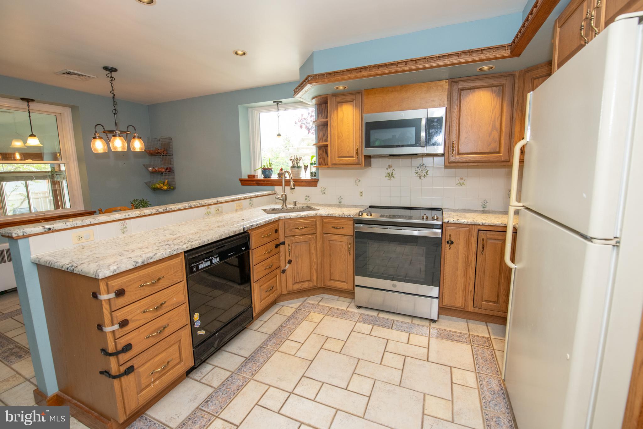 1259 Glenbrook Road Huntingdon Valley, PA 19006 - Photo 31 of 78 a kitchen with a stove a sink and a refrigerator