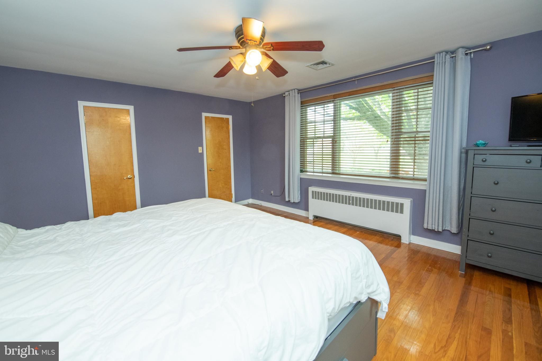 1259 Glenbrook Road Huntingdon Valley, PA 19006 - Photo 50 of 78 a bedroom with a bed and a flat tv screen on dresser