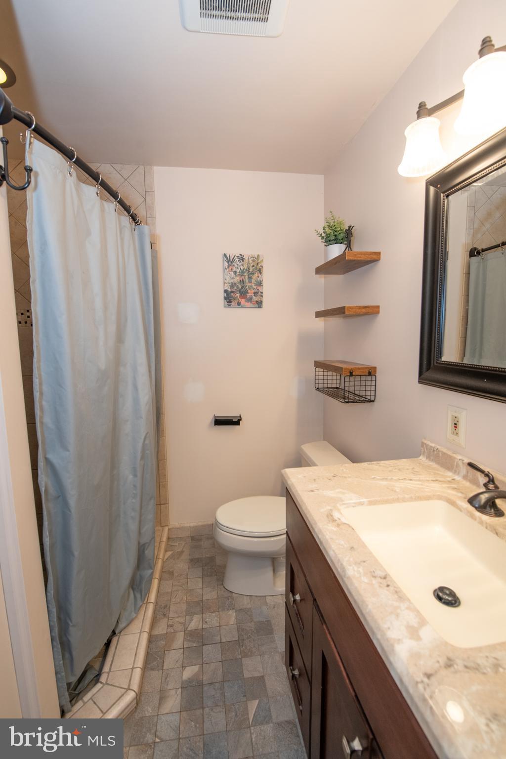 1259 Glenbrook Road Huntingdon Valley, PA 19006 - Photo 57 of 78 a bathroom with a granite countertop sink toilet and shower