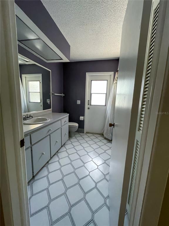 6336 Wooden Street New Port Richey, FL 34653 - Photo 12 of 13 a bathroom with a sink mirror and window