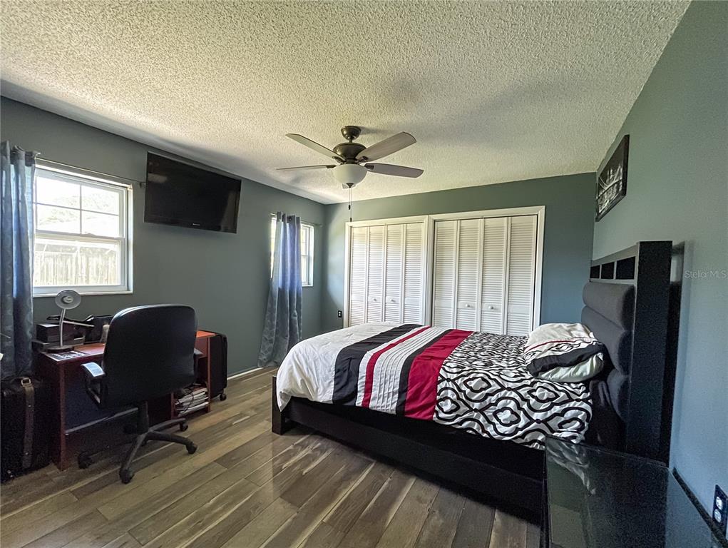 6336 Wooden Street New Port Richey, FL 34653 - Photo 6 of 13 a bedroom with a bed and a chair
