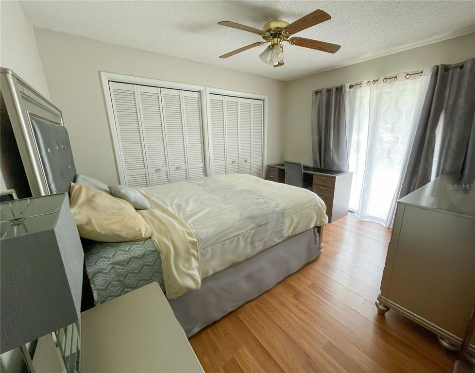6336 Wooden Street New Port Richey, FL 34653 - Photo 7 of 13 a bedroom with a bed closet and a mirror