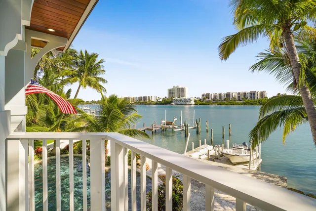 a living room with wooden floor and a large window