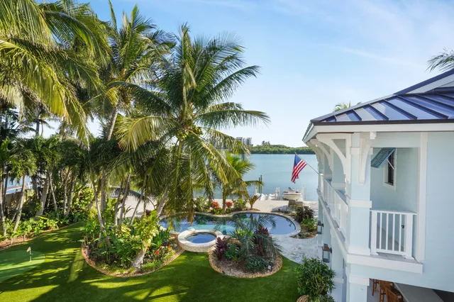 a bathroom with a granite countertop toilet sink and mirror