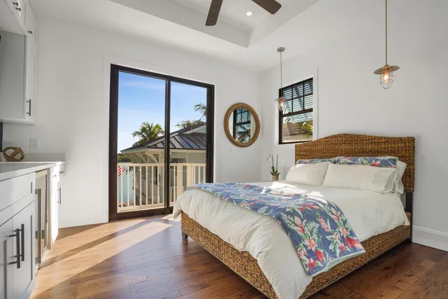 a view of a hallway with wooden floor and entryway