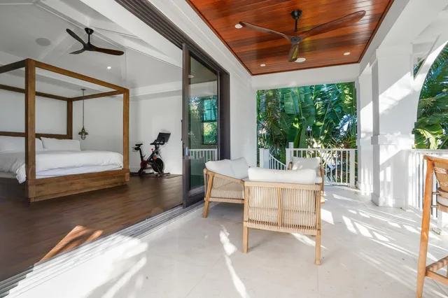 a living room with furniture a flat screen tv and a floor to ceiling window