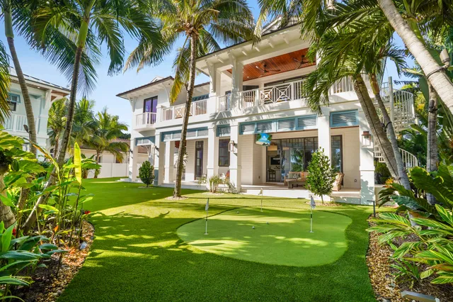 a front view of a house with a yard table and chairs