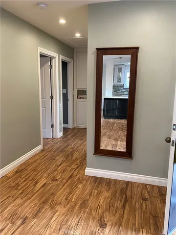 a view of a room with wooden floor and bathroom
