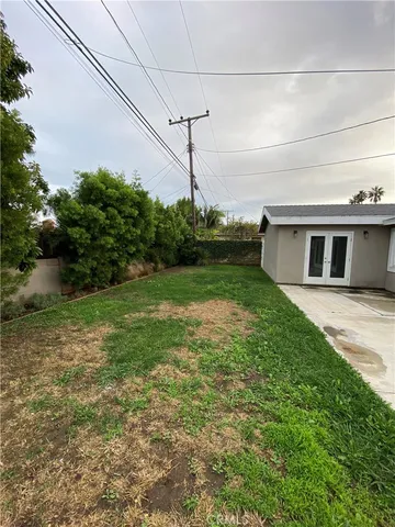 a view of a house with a backyard