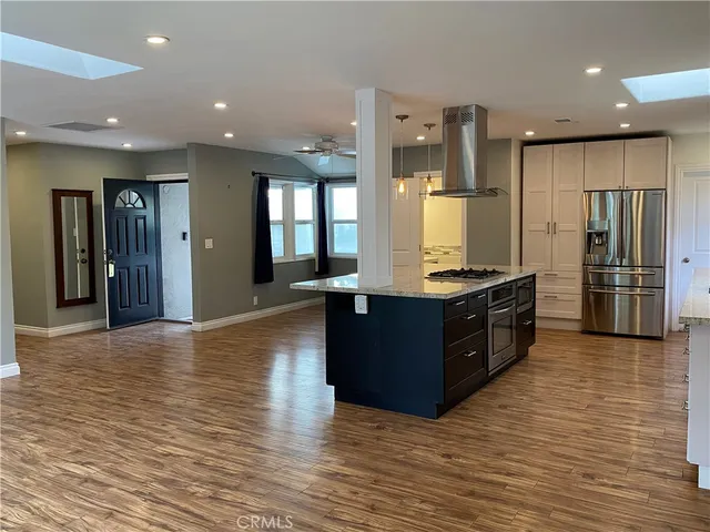 a kitchen with stainless steel appliances granite countertop a refrigerator and a stove