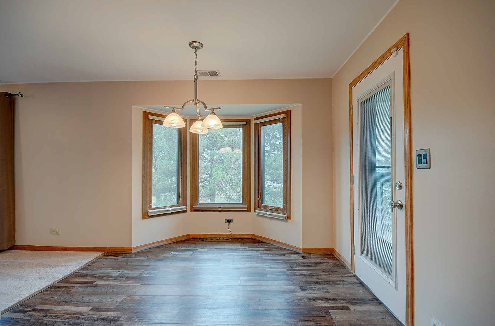 2757 Harbor Drive, Unit 2757 Joliet, IL 60431 - Photo 11 of 26 a view of an empty room with wooden floor and a window