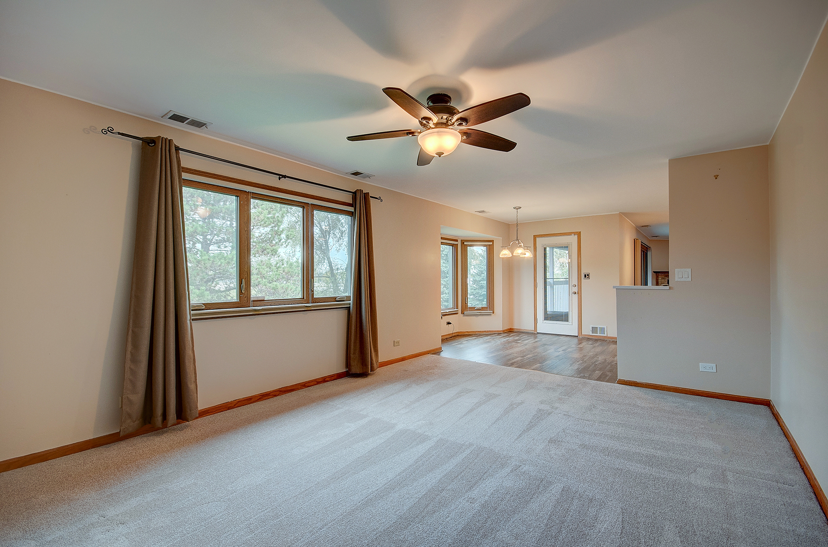 2757 Harbor Drive, Unit 2757 Joliet, IL 60431 - Photo 13 of 26 a view of n empty room with window and a kitchen