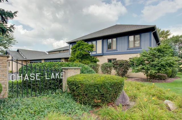 a backyard of a house with a garden and plants