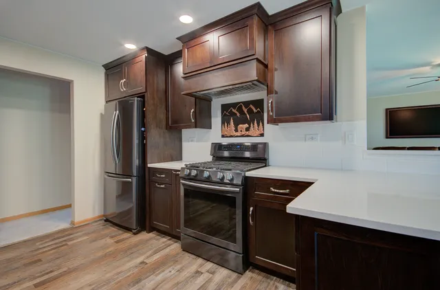 a kitchen with a refrigerator stove and microwave