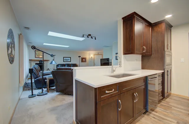 a kitchen with a sink cabinets and wooden floor